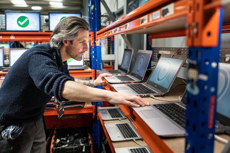 Staff member destroying data on laptops